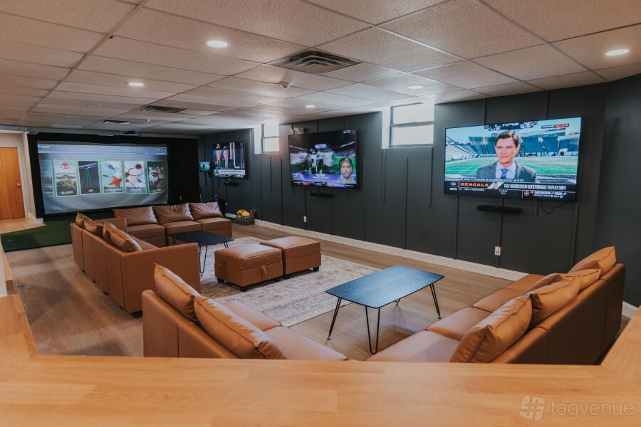 Christmas Pyjama Party: deep leather sofas facing big screens at Another Round, New York City