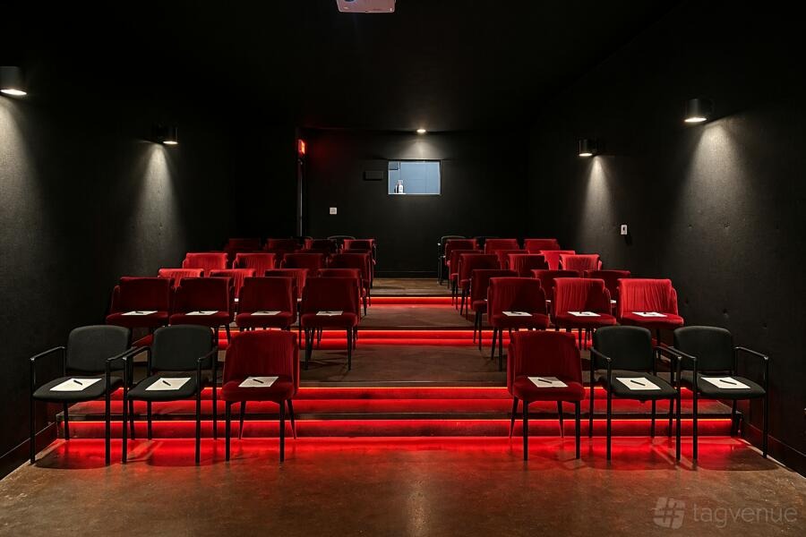 Christmas Movie Premiere: tiered red seating with red step lighting at The Lot in West Hollywood, Los Angeles