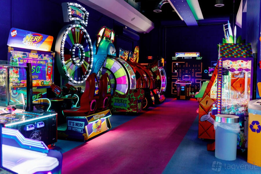 Candy Cane Carnival: arcade games and lit cocktail tables in saturated colour at FunDimension, Miami