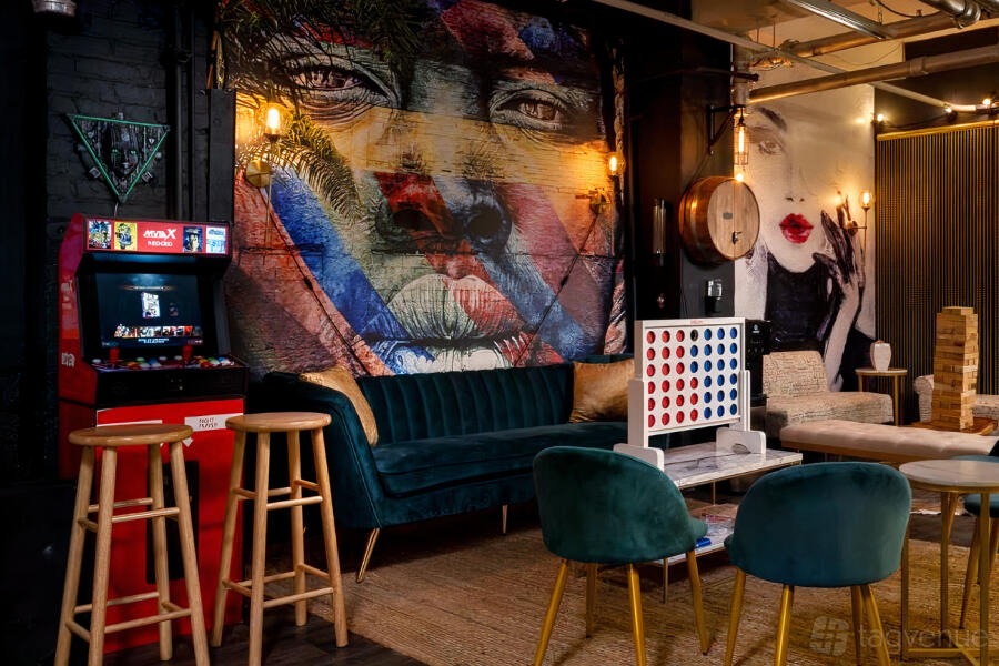 Tacky Christmas Olympics: games tables and a gold-lit bar at Coexist GameHouse, New York City