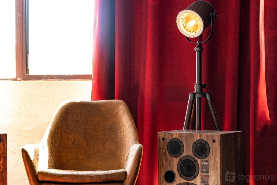 Wrapped for Christmas: deep red velvet backdrop lit by a single spotlight at The Boombox Room, New York City