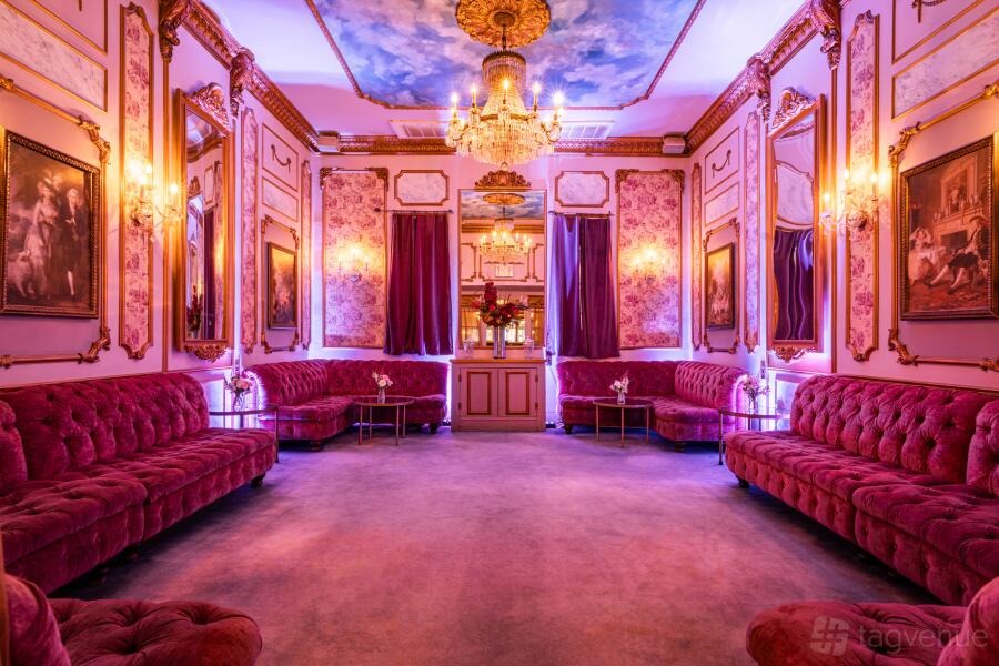 Gothic Christmas: deep red velvet banquettes, painted ceiling and chandelier at Dear Irving Gramercy, New York City