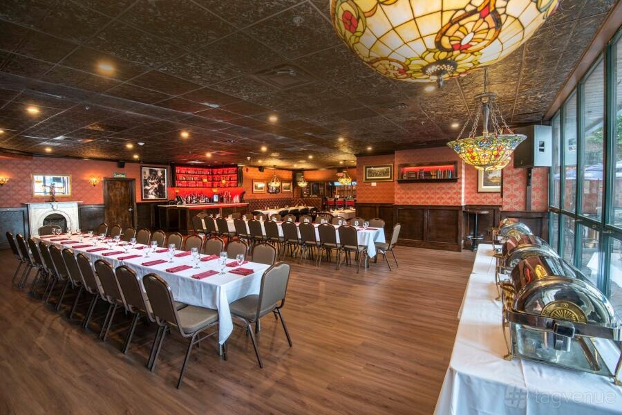 Country-House Christmas: stained-glass ceiling above red-and-white banquet tables at Village Tavern, Boston