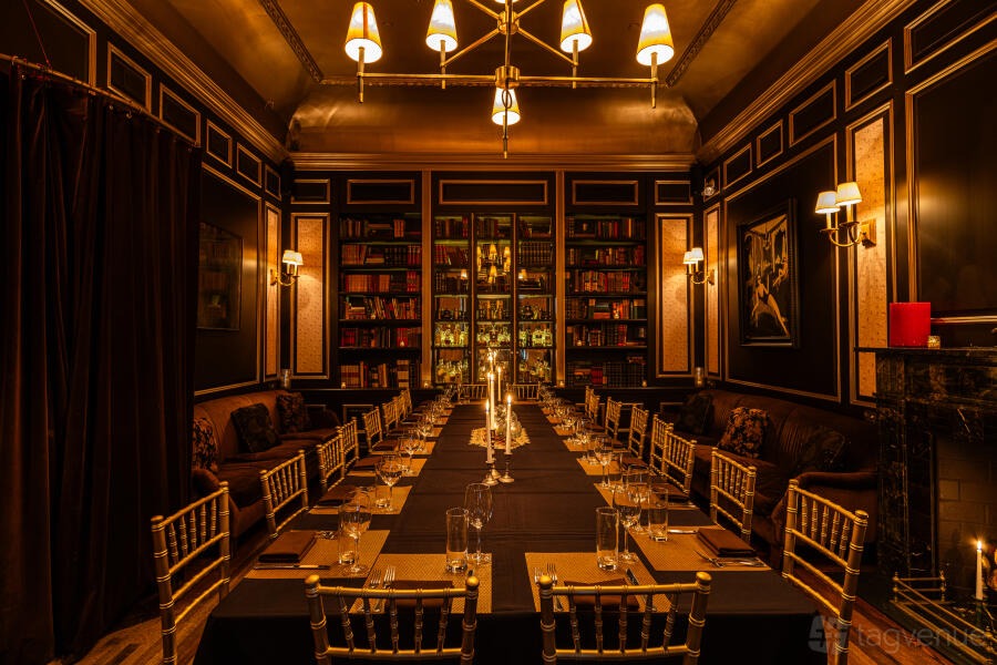 Bows and Baubles: candlelit panelled library with brass chandeliers at The Raines Law Room at The William, New York City