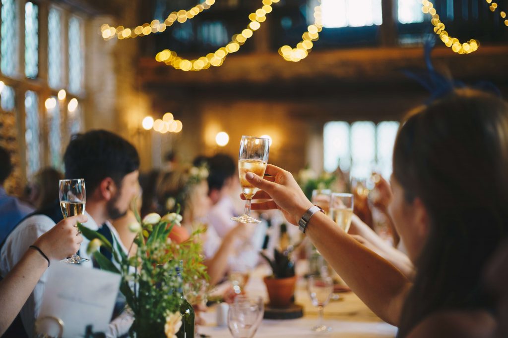 people at an engagement party, holding a flute of champagne