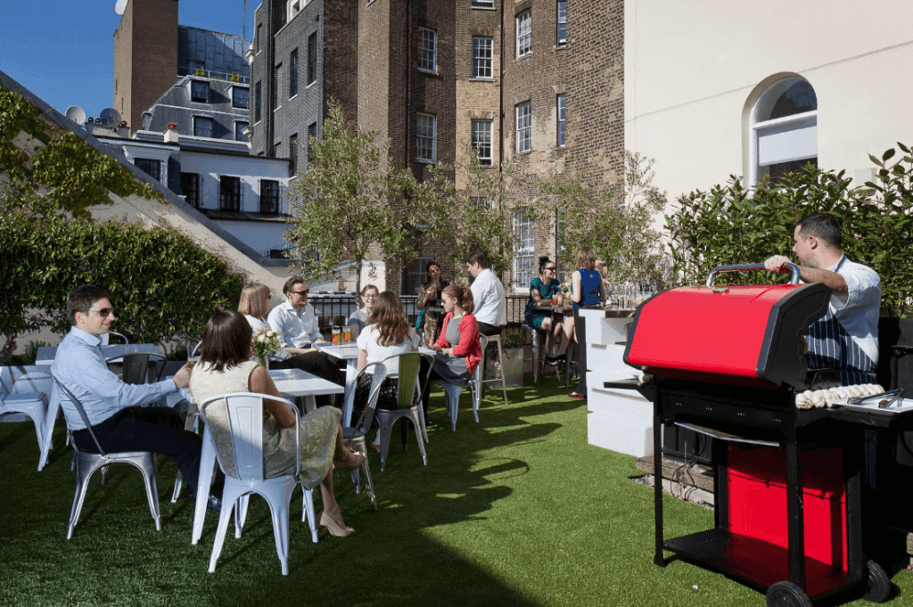 people sitting at the tables waiting for the BBQ guy