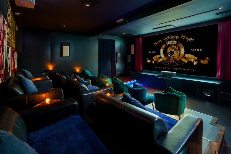 Boutique screening room with comfortable lounges and armchairs