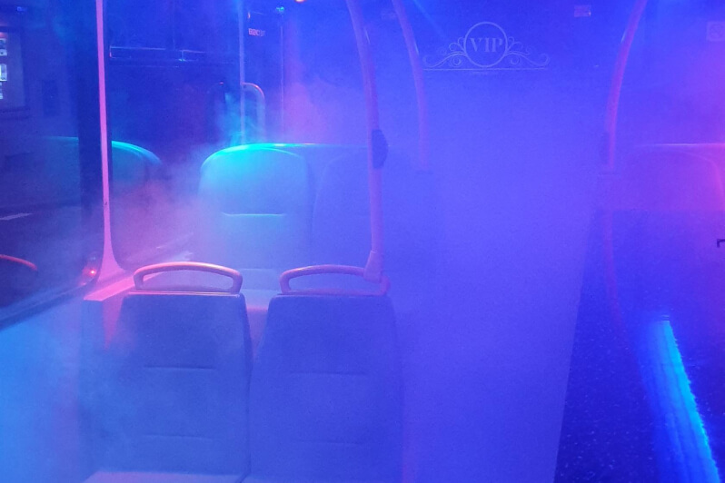 Party bus interior with blue and purple lights