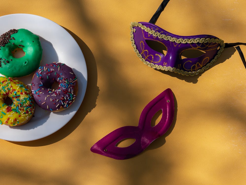 a picture of masquerade masks and yummy donuts