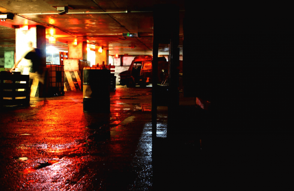 a dark underground parking lot turned laser tag arena