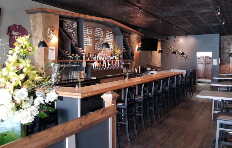 bar with a dark interior and wooden finishes