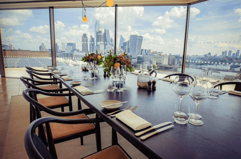 elegantly set up table in a room with a view of London