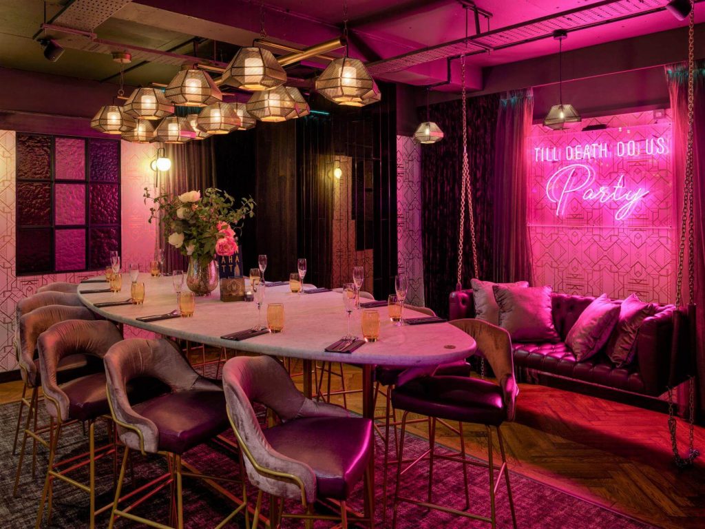 a fun and elegant private dining rom with pink neon lights in Birmingham