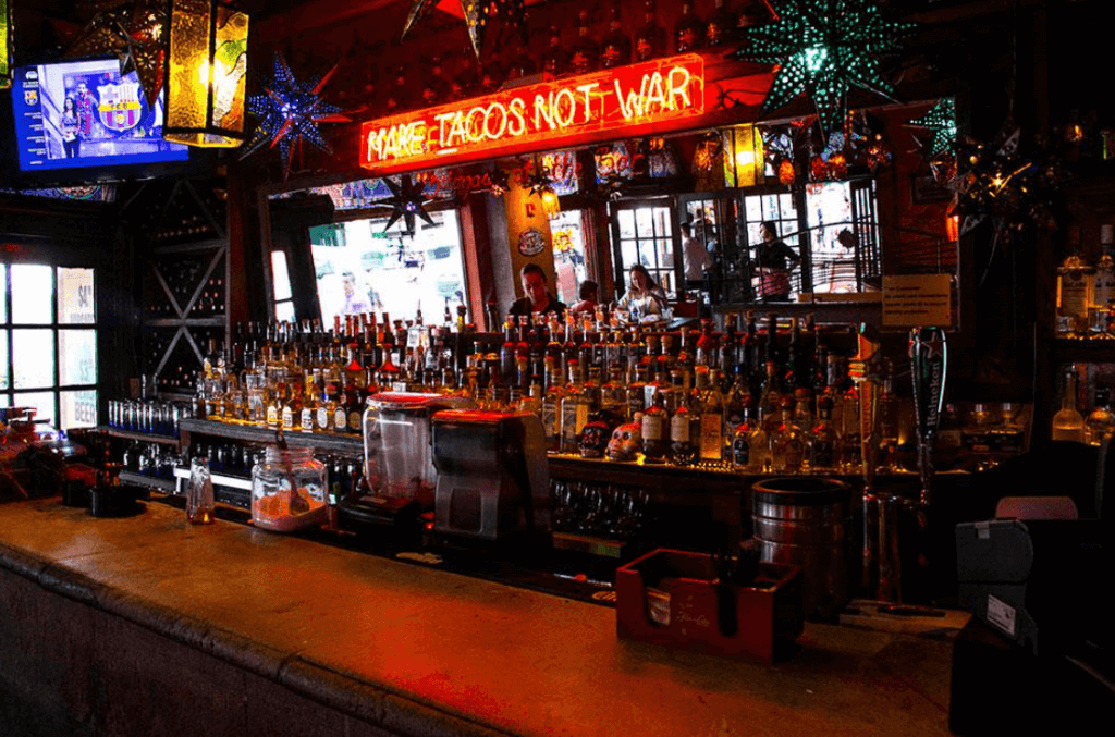 venue's bar filled with bottles of tequila and other spirits