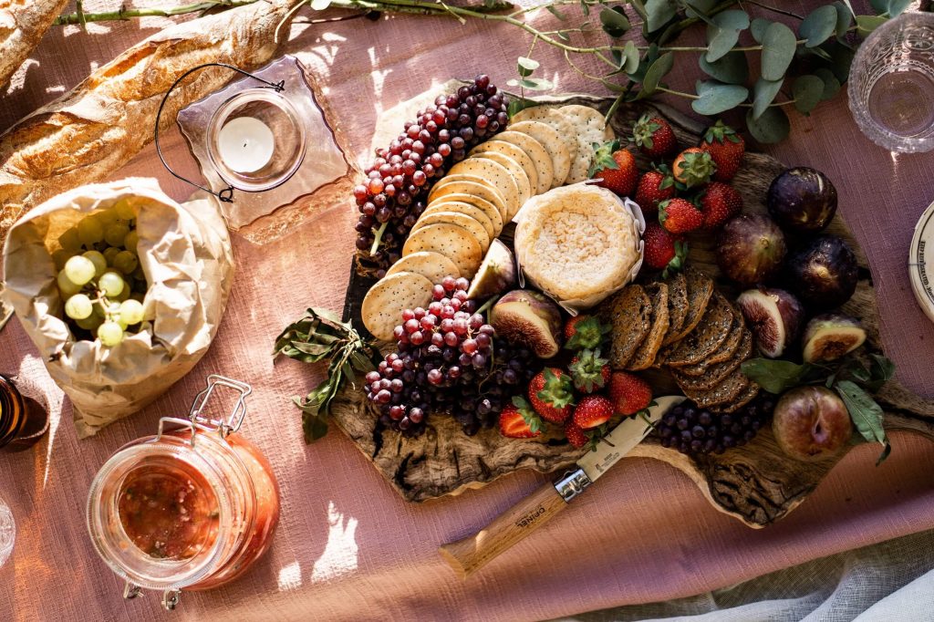 a delicious food board on pink linen tablectloth