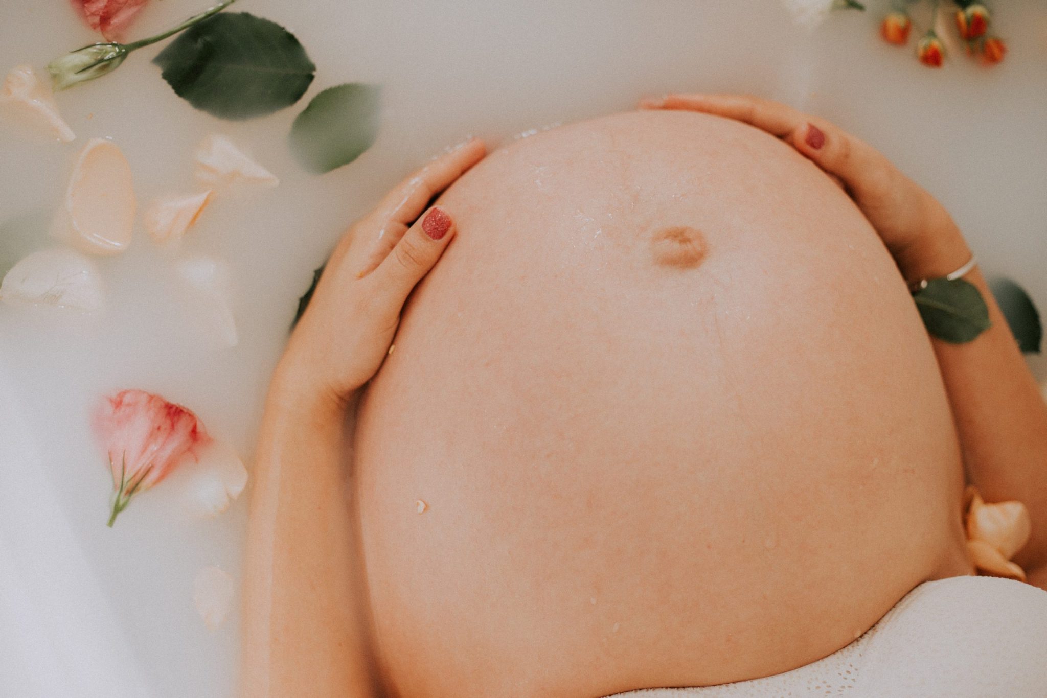 picture of a woman's baby bump in a bath