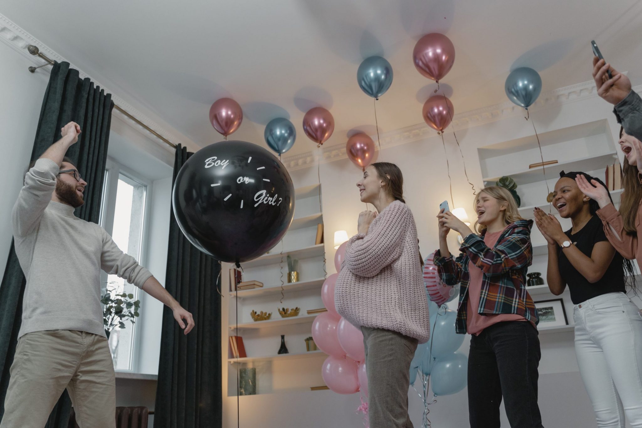people having fun at a gender reveal and baby shower joined party