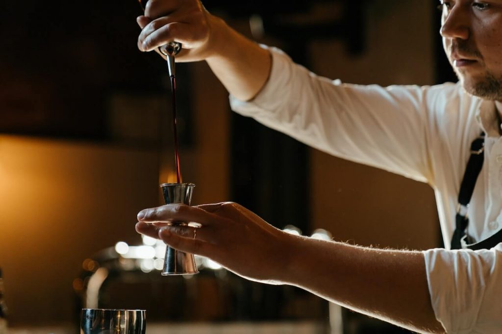 bartender pouring a shot 