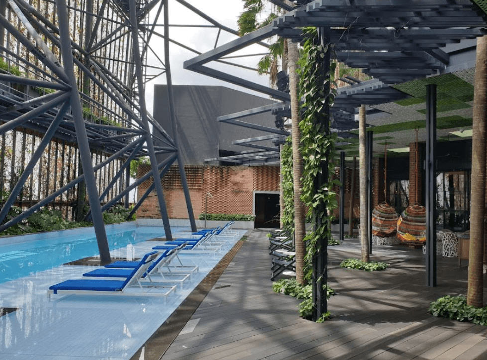 indoor pool with sun beds on the side