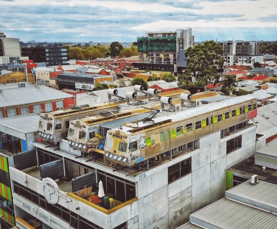 A building with three train cars on the top