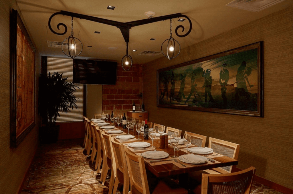 A private room with a table set up for a dinner
