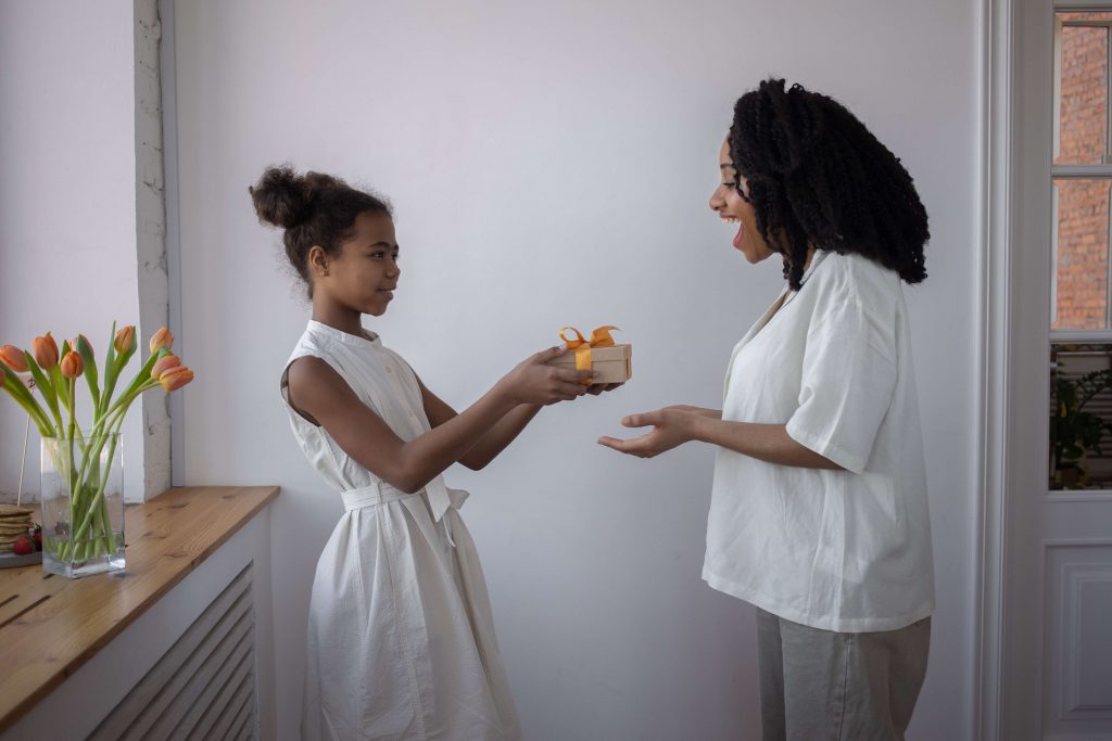 Two people exchanging gifts and smiling