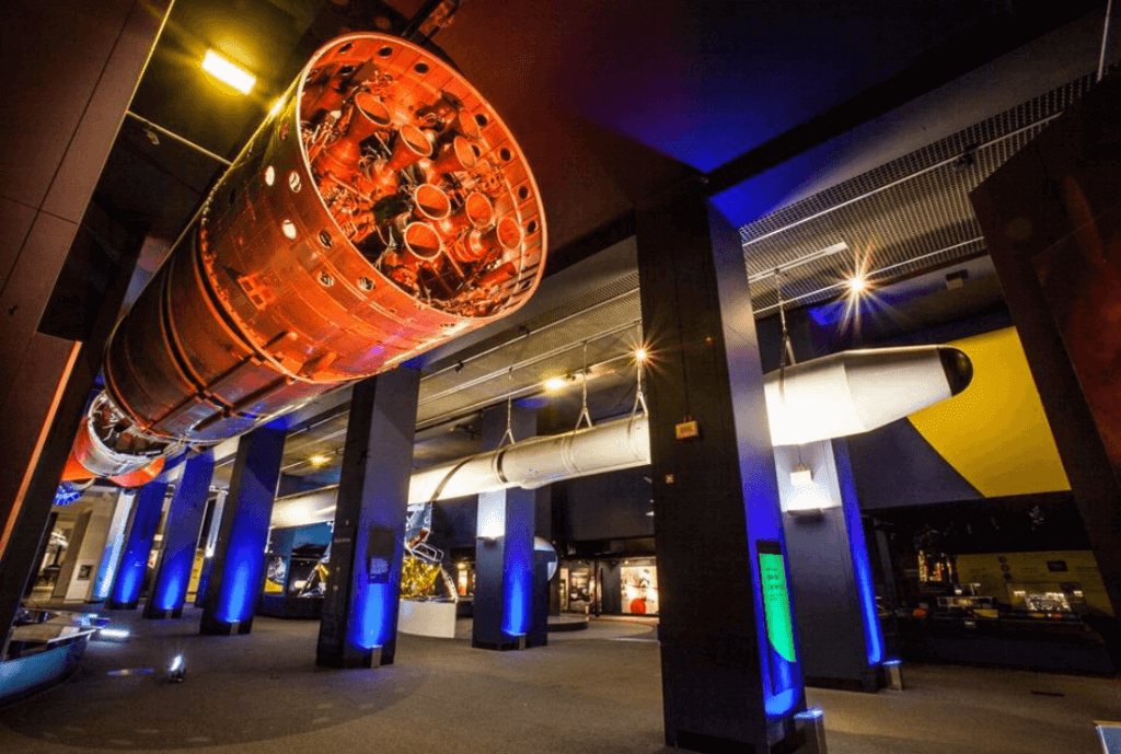 a museum room with real rockets on display