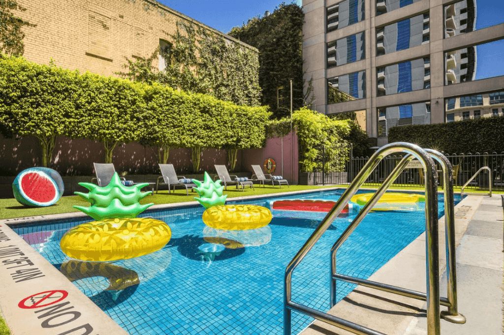 outdoor pool with sunbeds and colourful floaties