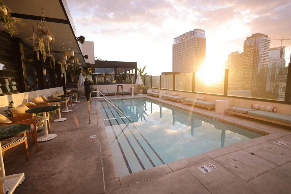 A rooftop swimming pool during a sunset