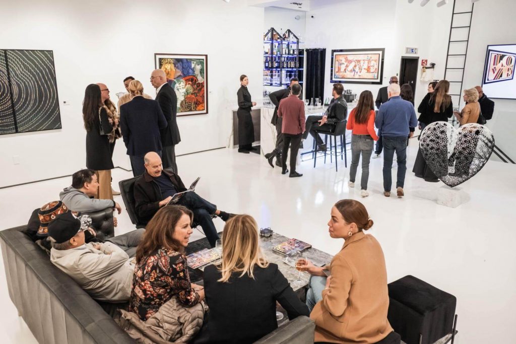 people chatting in an open space of an art gallery