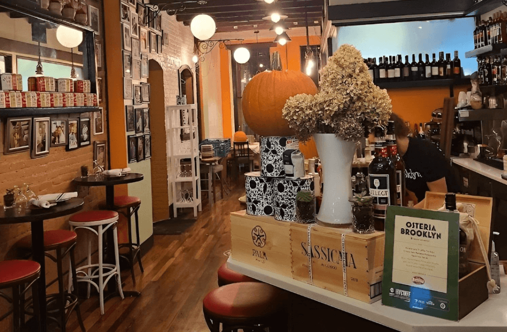 a dinner venue decorated with pumpkins and fall flowers