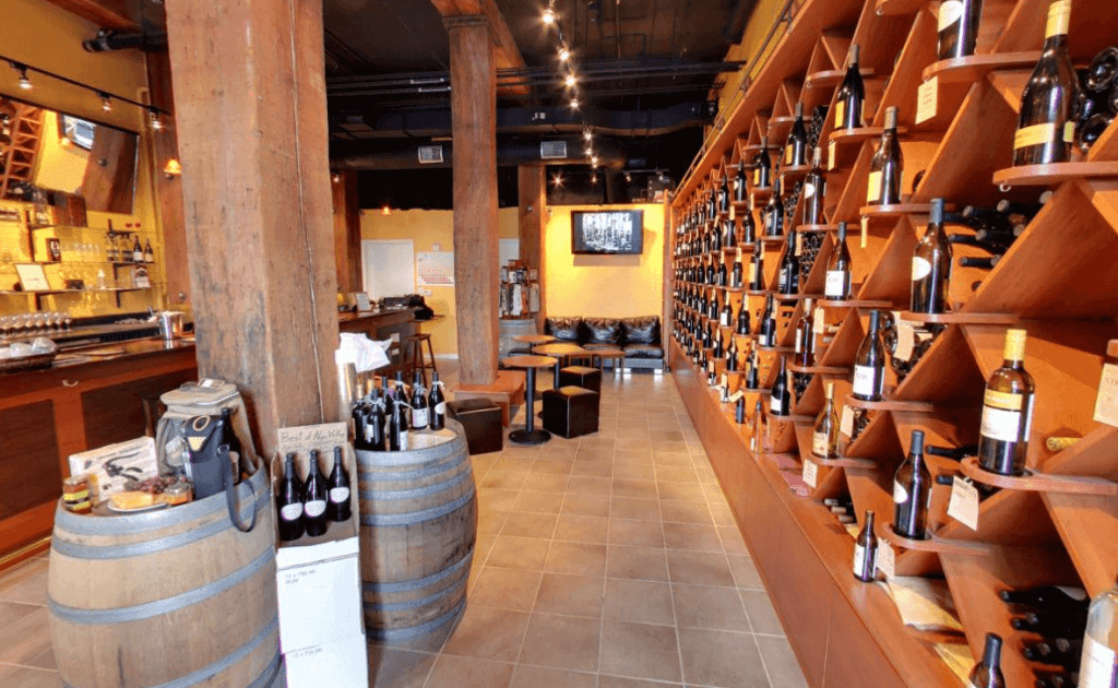 a venue with a shelf wall presenting different types of wines