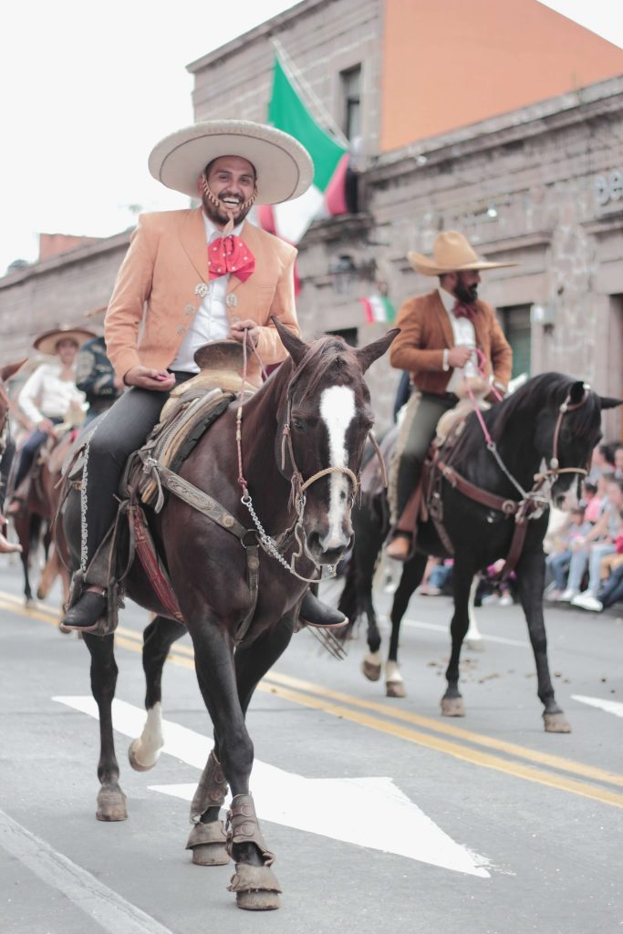 Wild Wild West theme represented by a man wearing a hat and a suit riding a horse