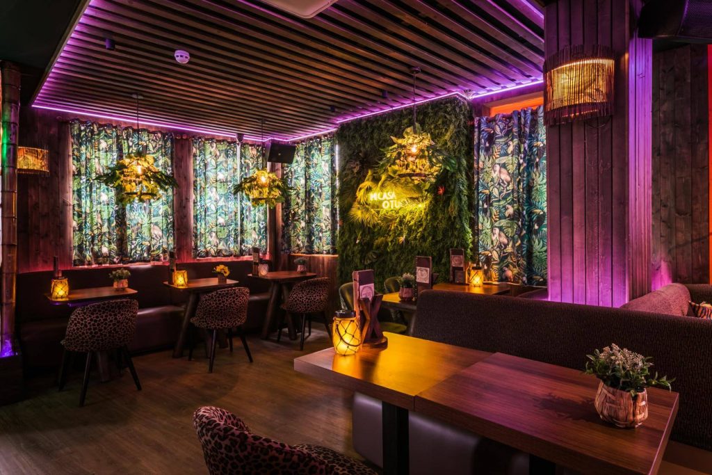 a restaurant room with tropical decorations
