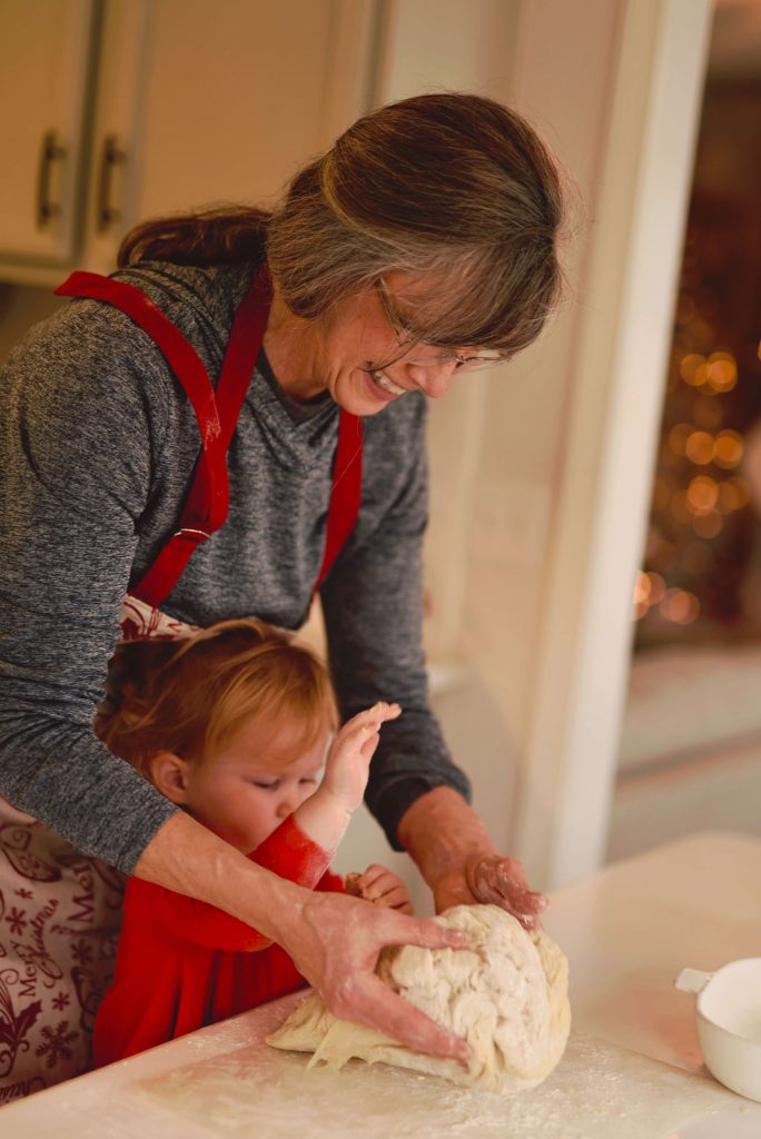 potluck party idea- a grandma kneading a dough with her grandchild