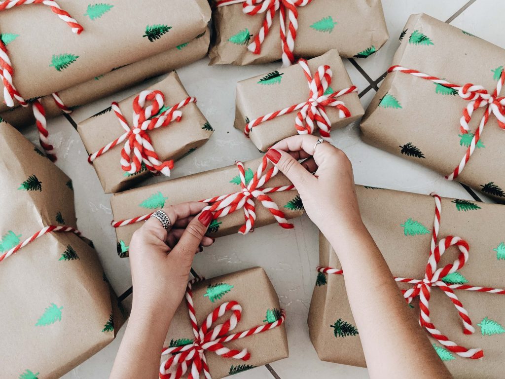 female hands wrapping up christmas presents