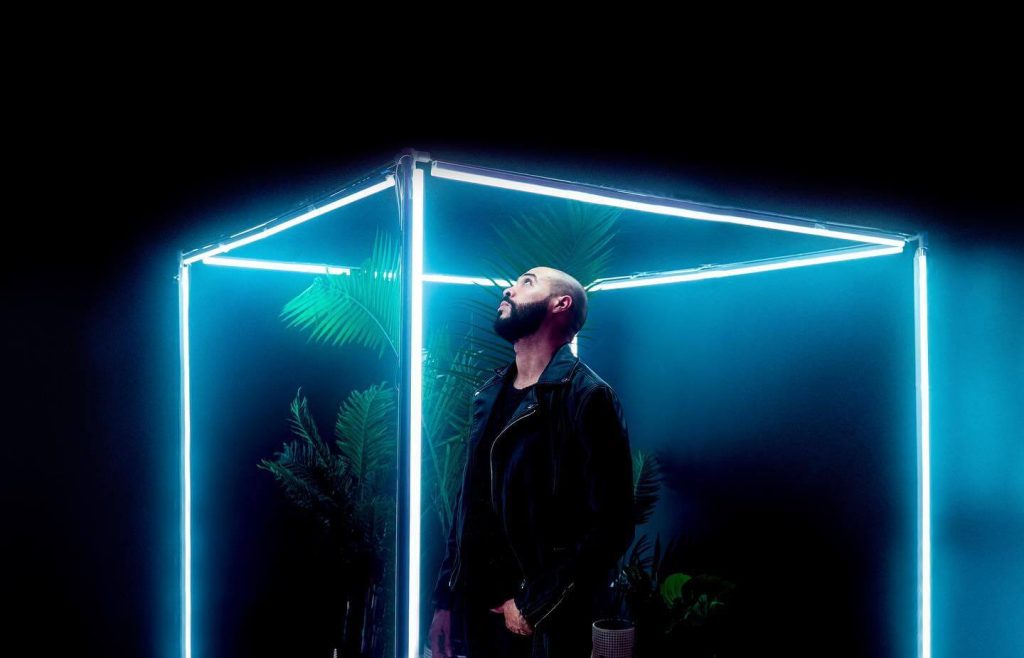 Man posing in a LED light up room
