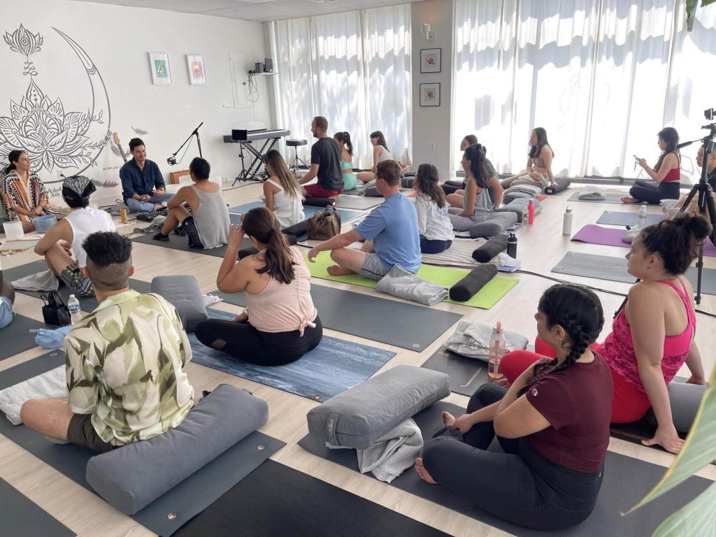 a room filled with people practicing yoga