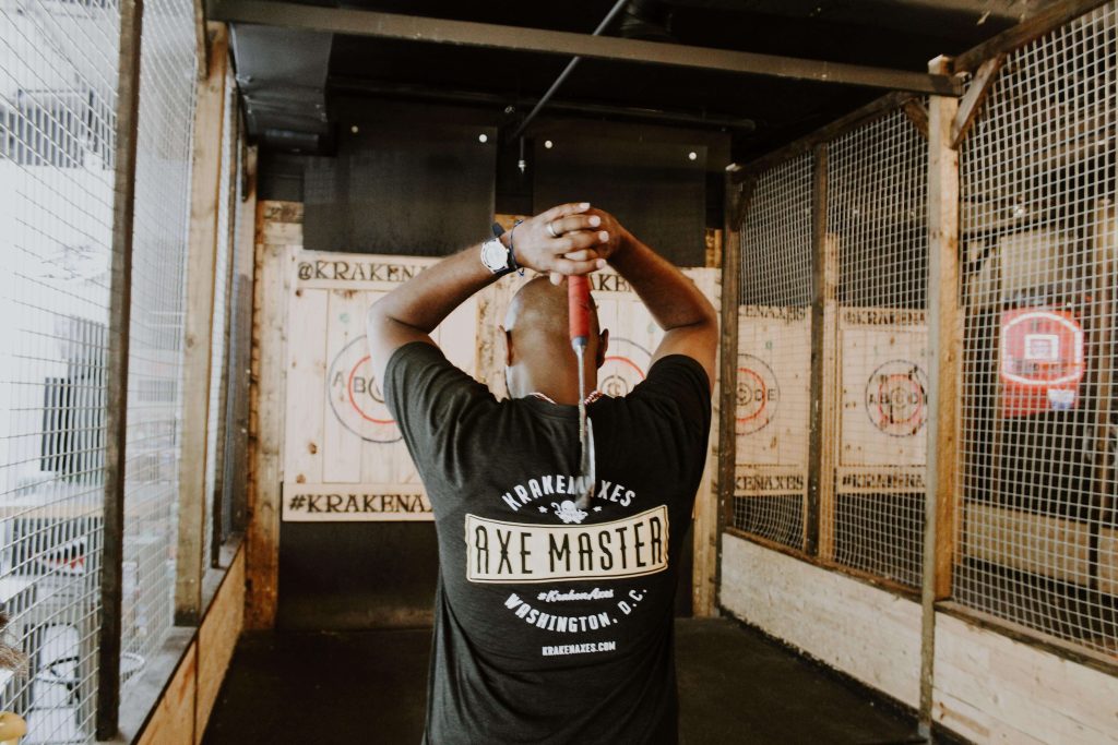 a man throwing an axe in a closed space