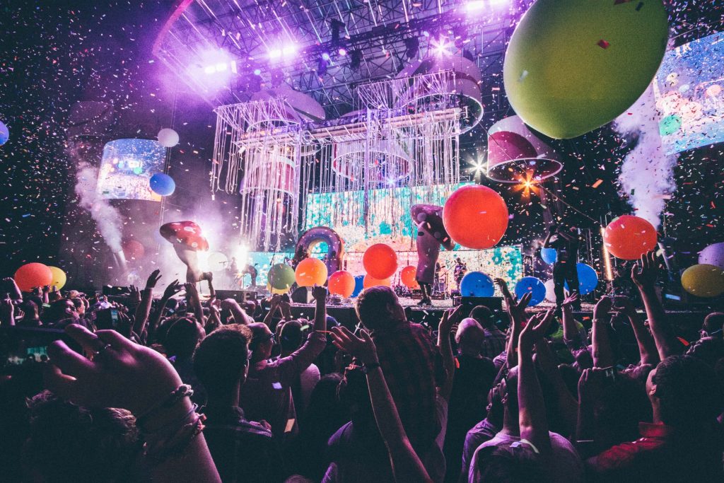 a view of a concert stage from the audience crowd