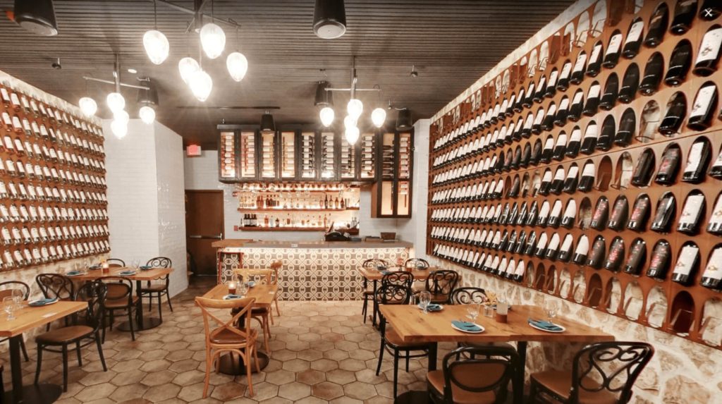 a restaurant room with various bottles of wine displayed on walls