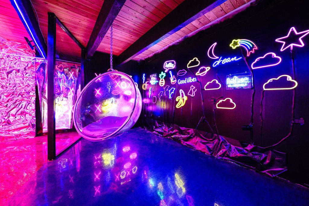 a colorful photo studio decorated with neon signs