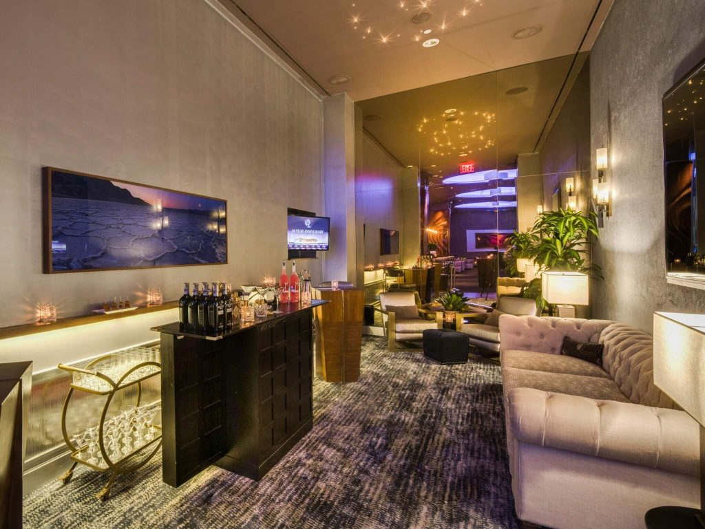 An elegant VIP lounge area at 48 Lounge NYC featuring plush seating, a sophisticated bar, and chic ambient lighting.