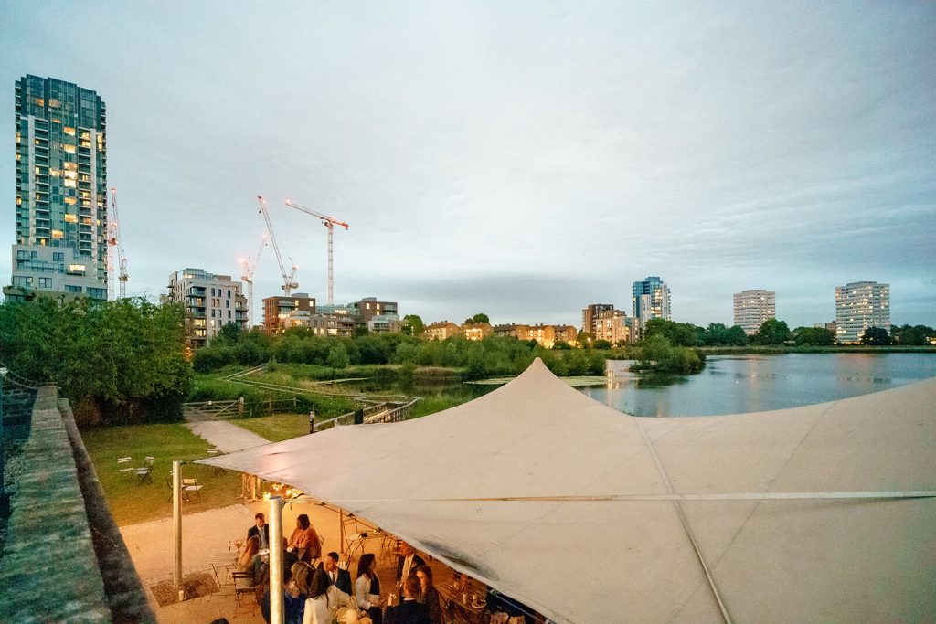 Outdoor summer party at Woodberry Wetlands with a spacious awning, a natural choice for summer events in London.