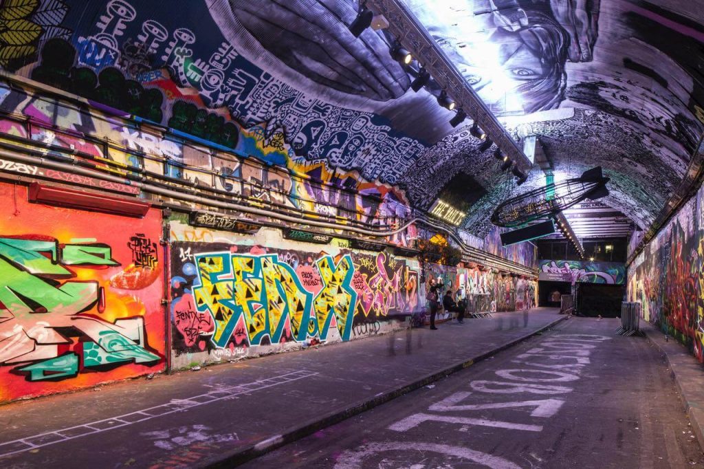 Colourful graffiti-covered walls at Leake Street Arches, London, a creative and edgy workshop location for a stag activity
