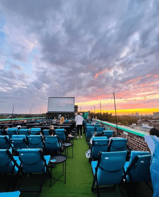 Rooftop cinema in London during sunset, an inspiring location for a summer film night party idea in the capital.