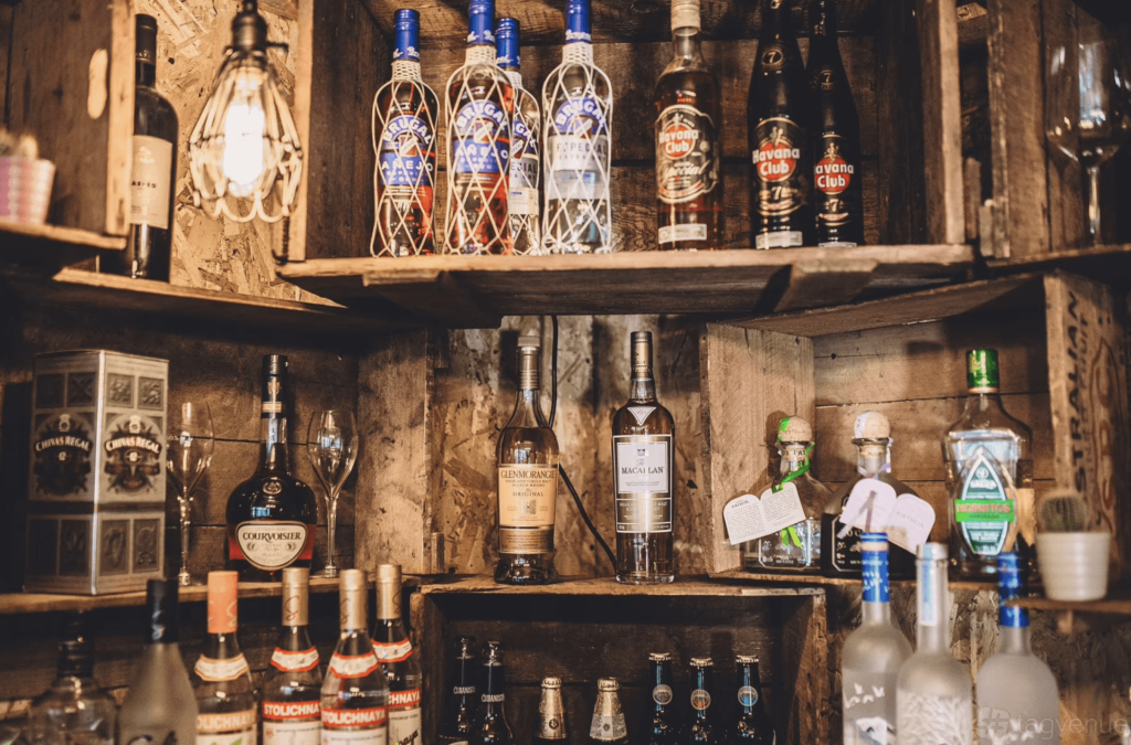 bottles of rum and whiskey against a rustic wooden decor