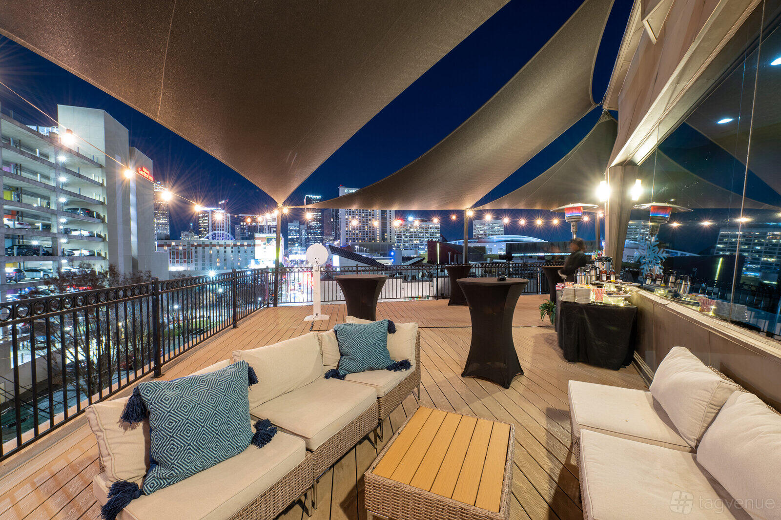 A rooftop event venue with city skyline views, sail shade canopies, and outdoor lounge seating at Terminus 330.