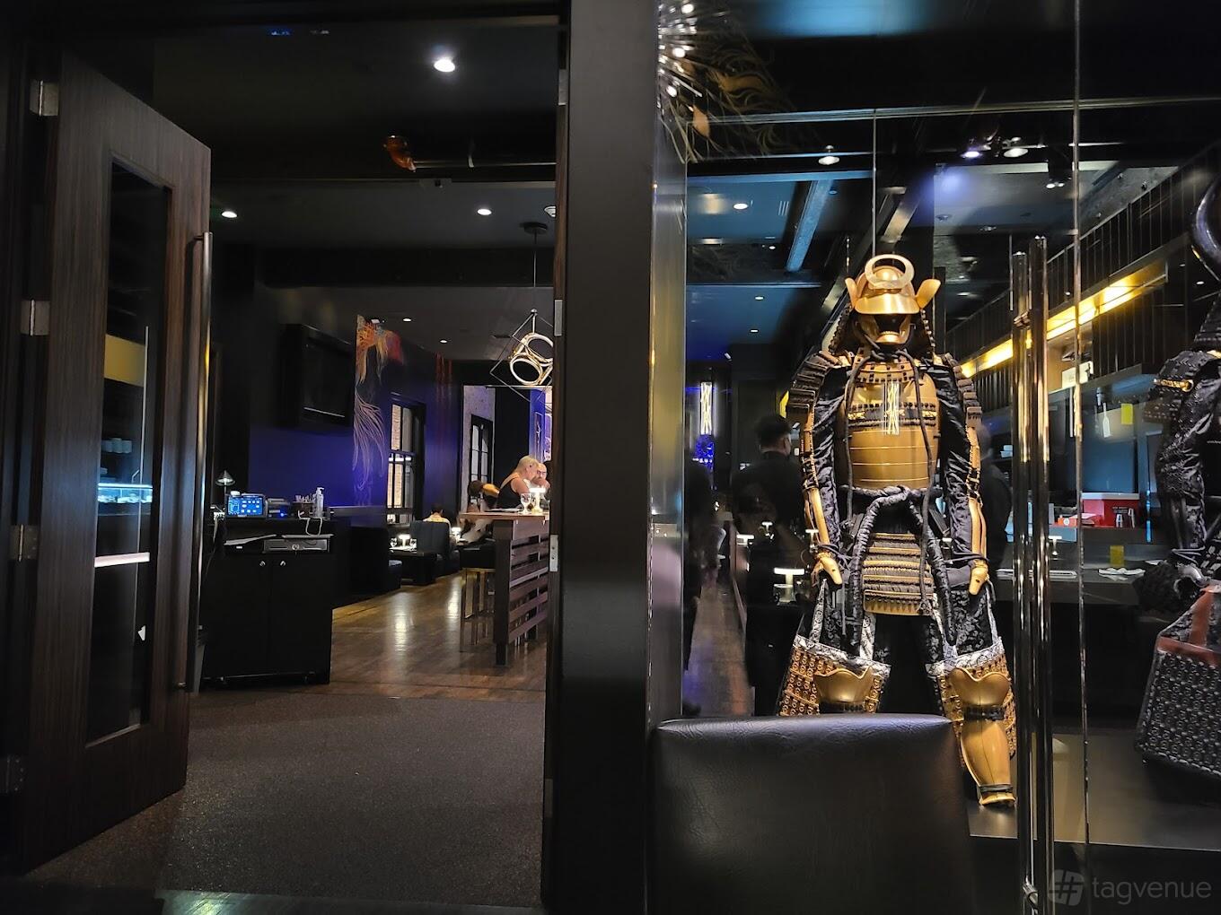 A restaurant private room with glass partitions and a display of traditional samurai armor at KAVIAR Pasadena.