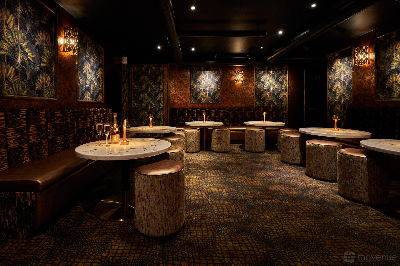 A restaurant lounge with patterned wall panels, round marble tables, and upholstered seating at Amici Soho.